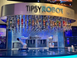 caption: This bar inside Planet Hollywood on the Las Vegas strip has two robots that serve customers drinks. The Tipsy Robot opened a second location on the strip this year.