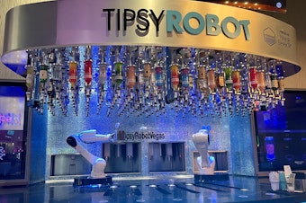 caption: This bar inside Planet Hollywood on the Las Vegas strip has two robots that serve customers drinks. The Tipsy Robot opened a second location on the strip this year.