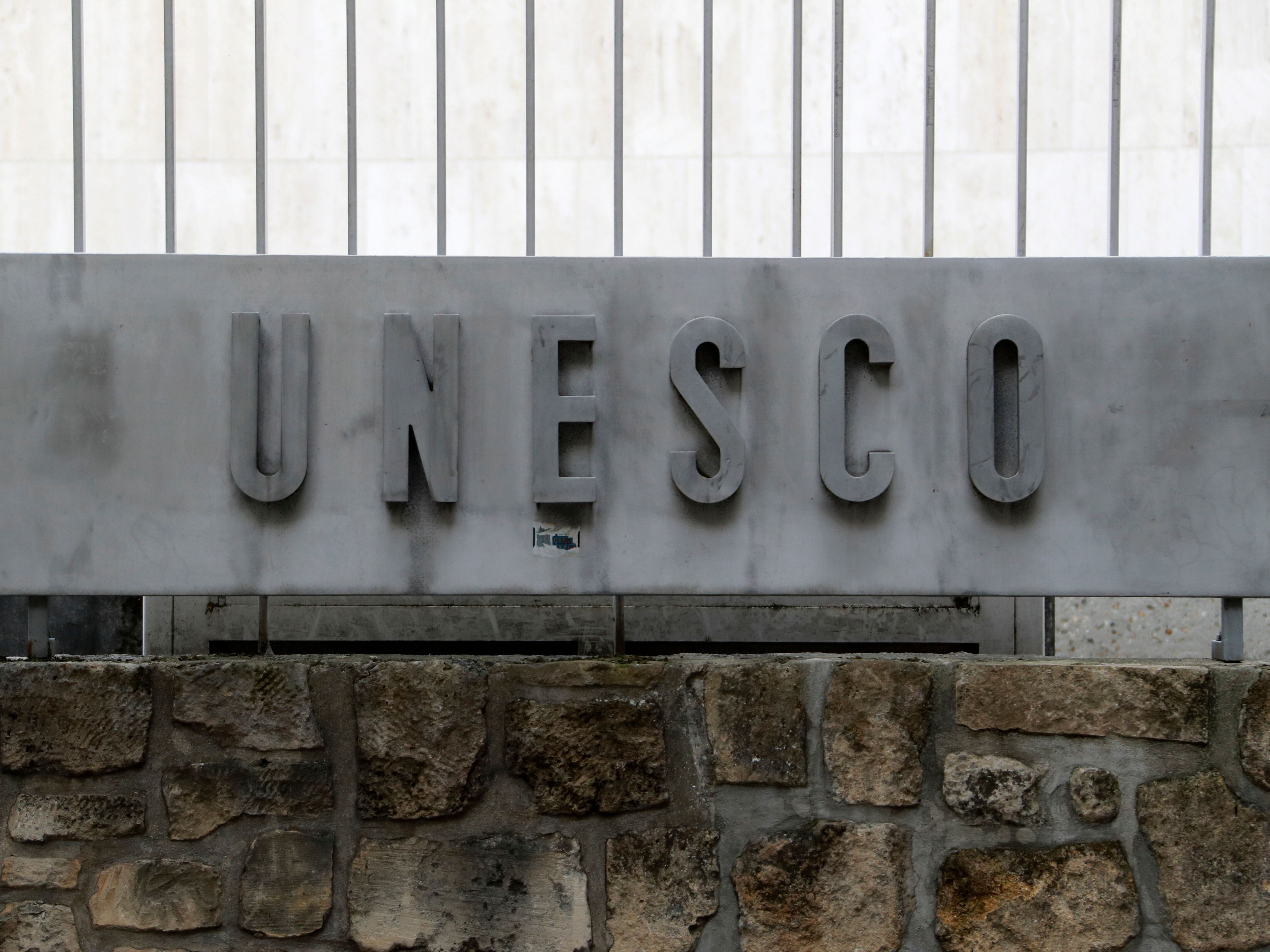 caption: A picture taken on Oct. 12, 2017 shows the logo of the United Nations Educational, Scientific and Cultural Organization (UNESCO) headquarters in Paris.