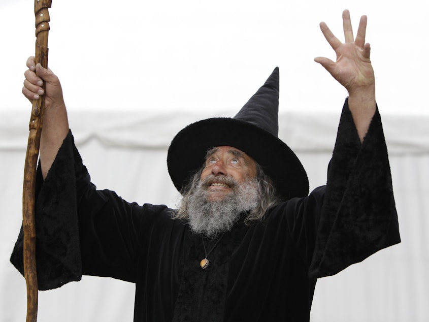 caption: The Wizard of New Zealand, also known as Ian Brackenbury Channell, casts a "spell" during a television interview in Christchurch, New Zealand, in March 2011. His contract with the city will end in December after more than two decades.