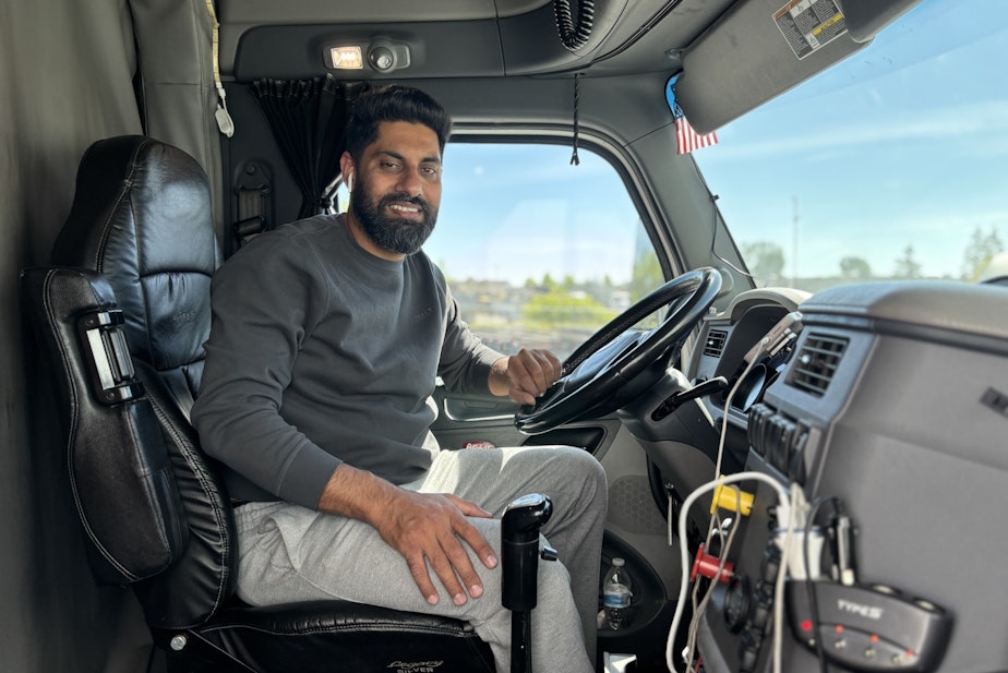 caption: Gagandeep Sandhu hauls containers between the Ports of Seattle/Tacoma and local warehouses all day. Lately, his workdays have been ending unusually early, as Spirit's customers have fewer containers to haul. Less work means less pay for Sandhu.