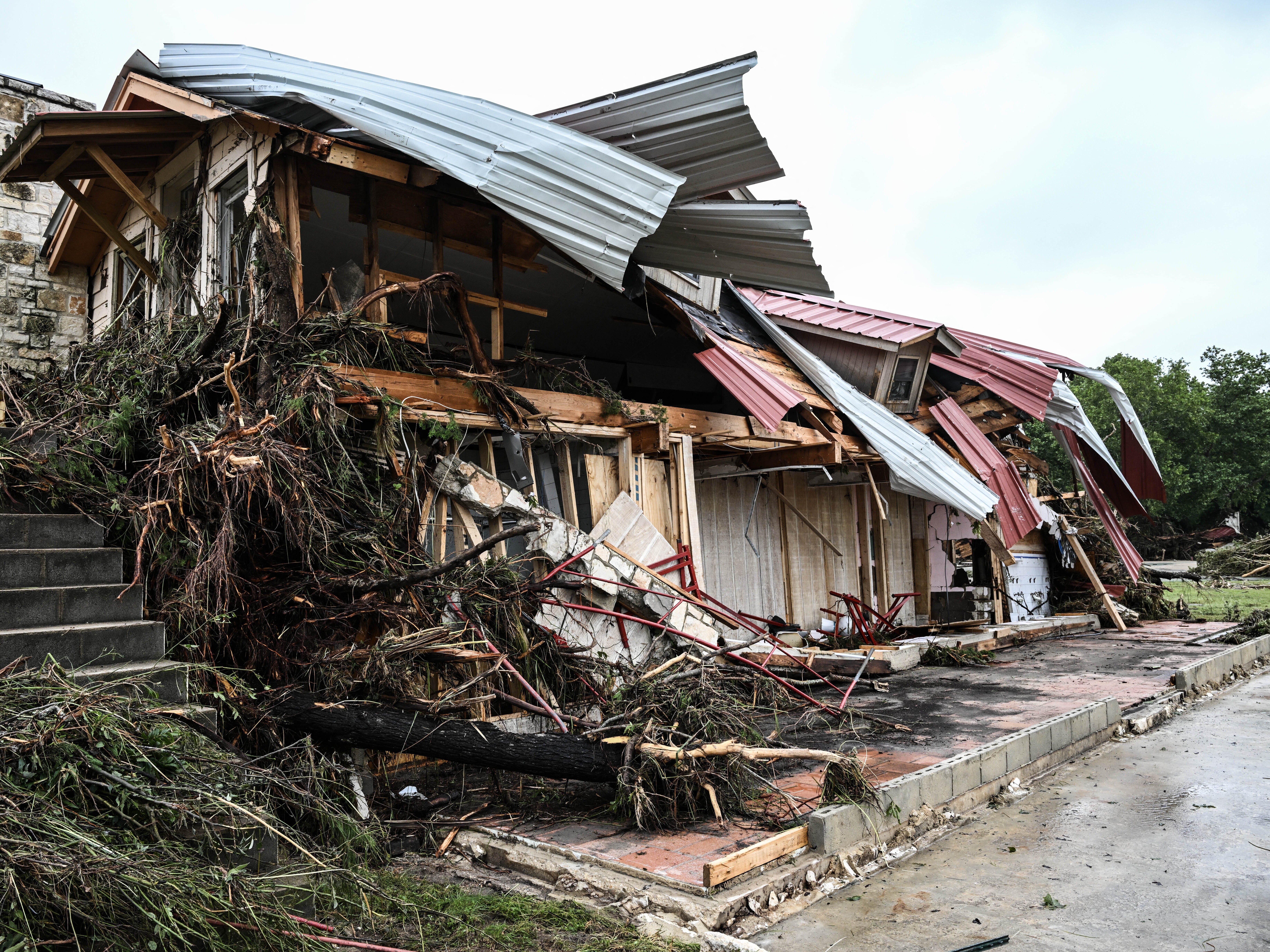 caption: A damaged home is seen after flash flooding in Hunt, Texas, on July 4. Just 4% of homeowners nationwide have flood insurance, according to the Federal Emergency Management Agency.