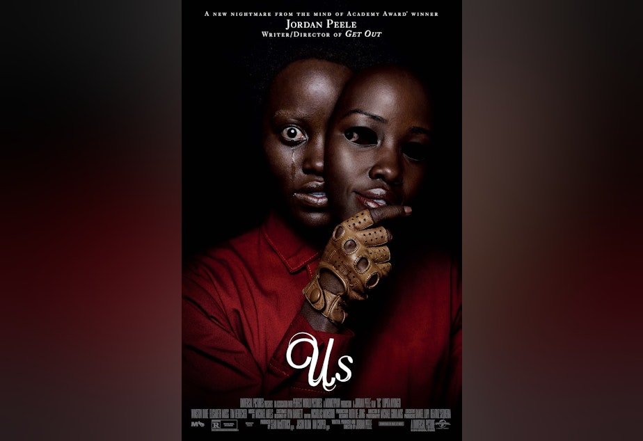 caption: The theatrical release poster of Us.