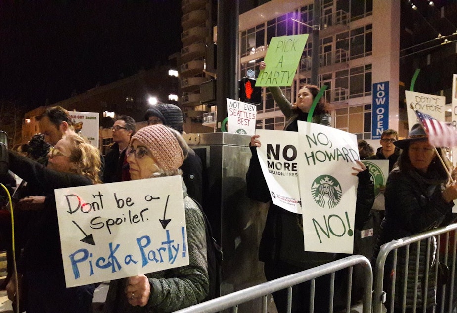Protesters outside Seattle's Moore Theater try to encourage Howard Schultz to reconsider a run for the presidency.