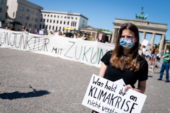 caption: Luisa-Marie Neubauer of Fridays for Future takes part in a demonstration in front of the Brandenburg Gate in Berlin on June 2. The protest took place while government leaders discussed economic stimulus and other strategies in the fight against the coronavirus.