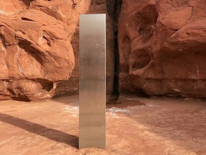 caption: This Nov. 18 photo, provided by the Utah Department of Public Safety, shows a metal monolith in the ground in a remote area in Utah. The mysterious monolith has disappeared less than 10 days after it was spotted by wildlife biologists.