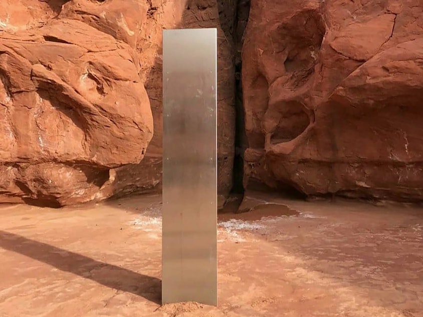 caption: This Nov. 18 photo, provided by the Utah Department of Public Safety, shows a metal monolith in the ground in a remote area in Utah. The mysterious monolith has disappeared less than 10 days after it was spotted by wildlife biologists.