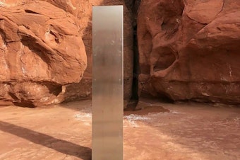caption: This Nov. 18 photo, provided by the Utah Department of Public Safety, shows a metal monolith in the ground in a remote area in Utah. The mysterious monolith has disappeared less than 10 days after it was spotted by wildlife biologists.