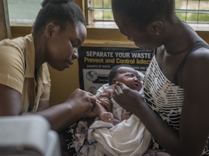 caption: A nurse administers the world's first malaria vaccine during a 2019 pilot program in Ghana. The World Health Organization has now recommended the vaccine for use in countries with moderate to high levels of malaria transmission.