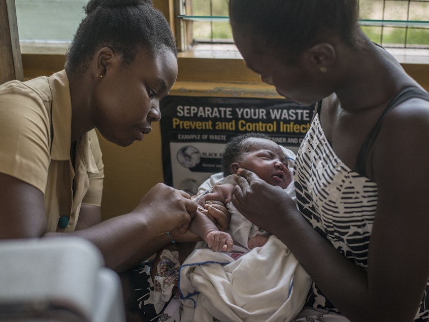 caption: A nurse administers the world's first malaria vaccine during a 2019 pilot program in Ghana. The World Health Organization has now recommended the vaccine for use in countries with moderate to high levels of malaria transmission.