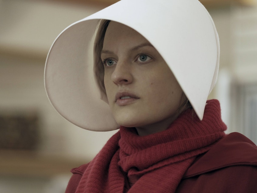 caption: <em>The Handmaid's Tale</em>, starring Elisabeth Moss, coincided with a spike in new subscribers to Hulu, one of an increasing number of video streaming platforms.
