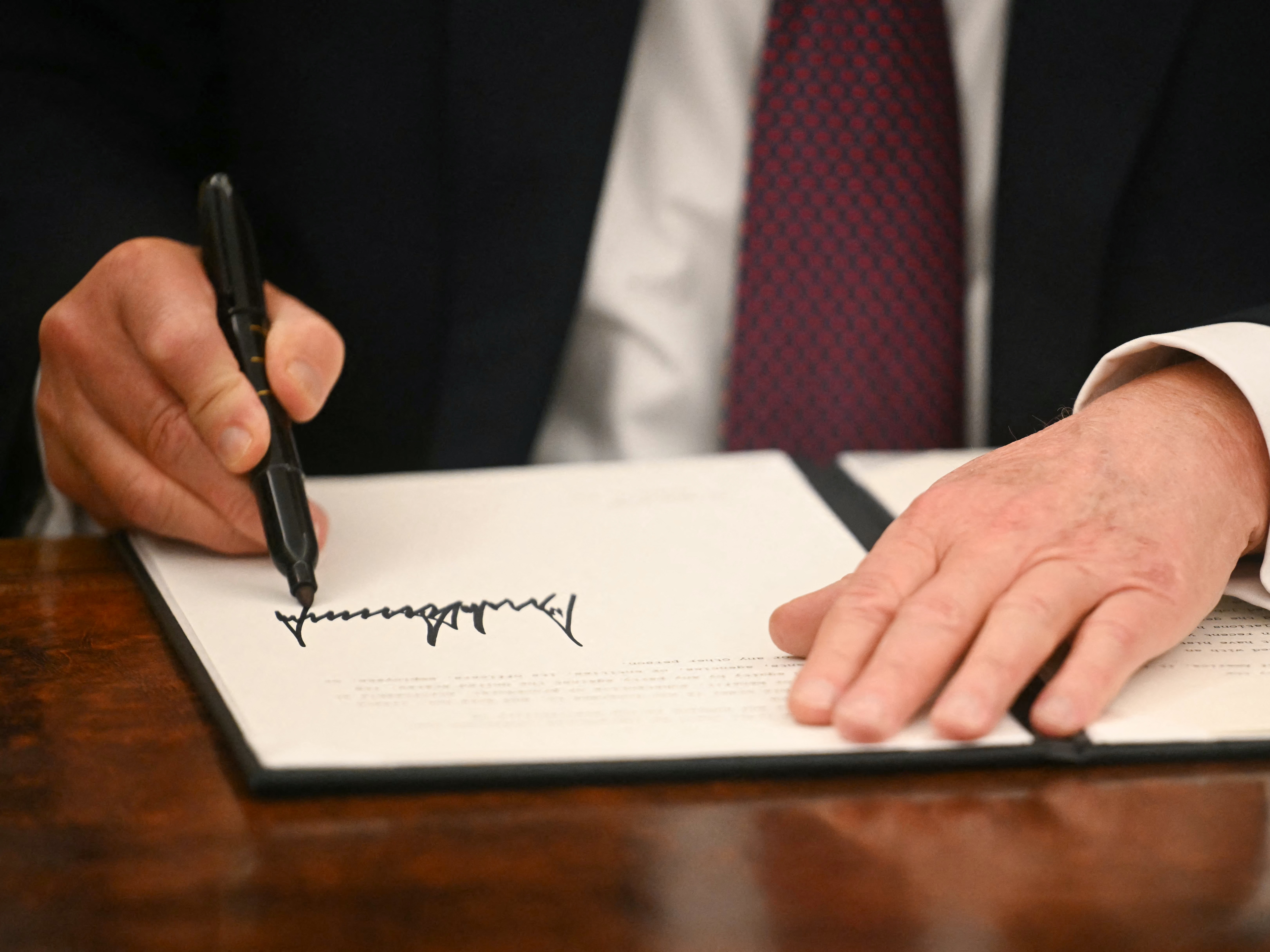 caption: President Trump signs an executive order in the Oval Office of the White House on Jan. 20. Trump has used executive orders to establish multiple national emergencies, which give him access to expanded powers.