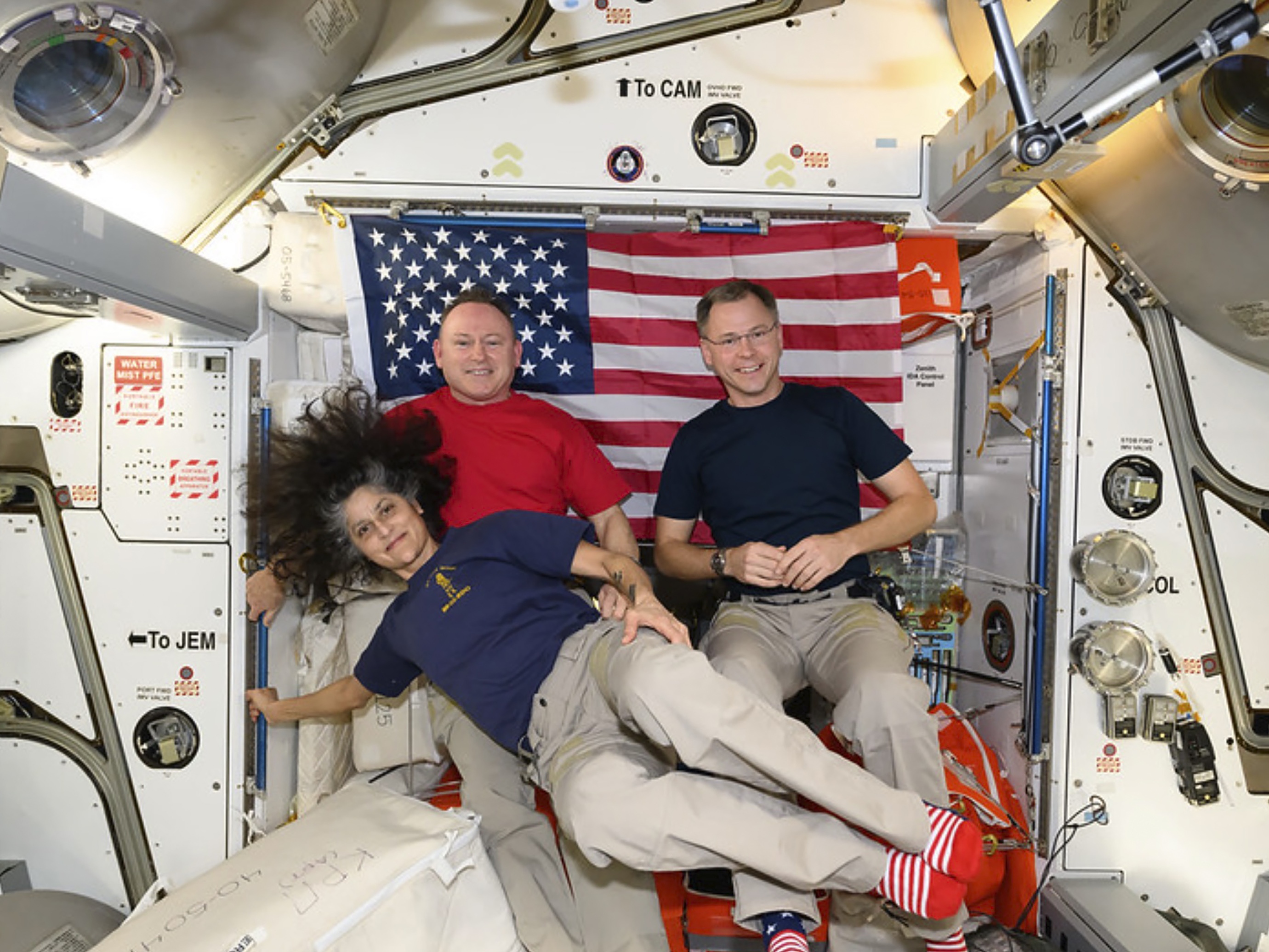 caption: Astronauts Suni Williams (lower) and Butch Wilmore (left) were originally supposed to return to Earth in June of last year. Instead, they've been part of the latest crew of the International Space Station, along with astronaut Nick Hague (right).