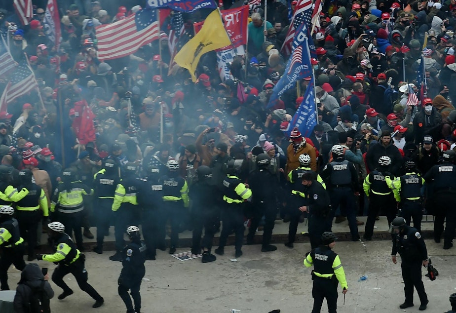 caption: Police hold back supporters of US President Donald Trump as they gather outside the US Capitol's Rotunda on January 6, 2021, in Washington, DC.