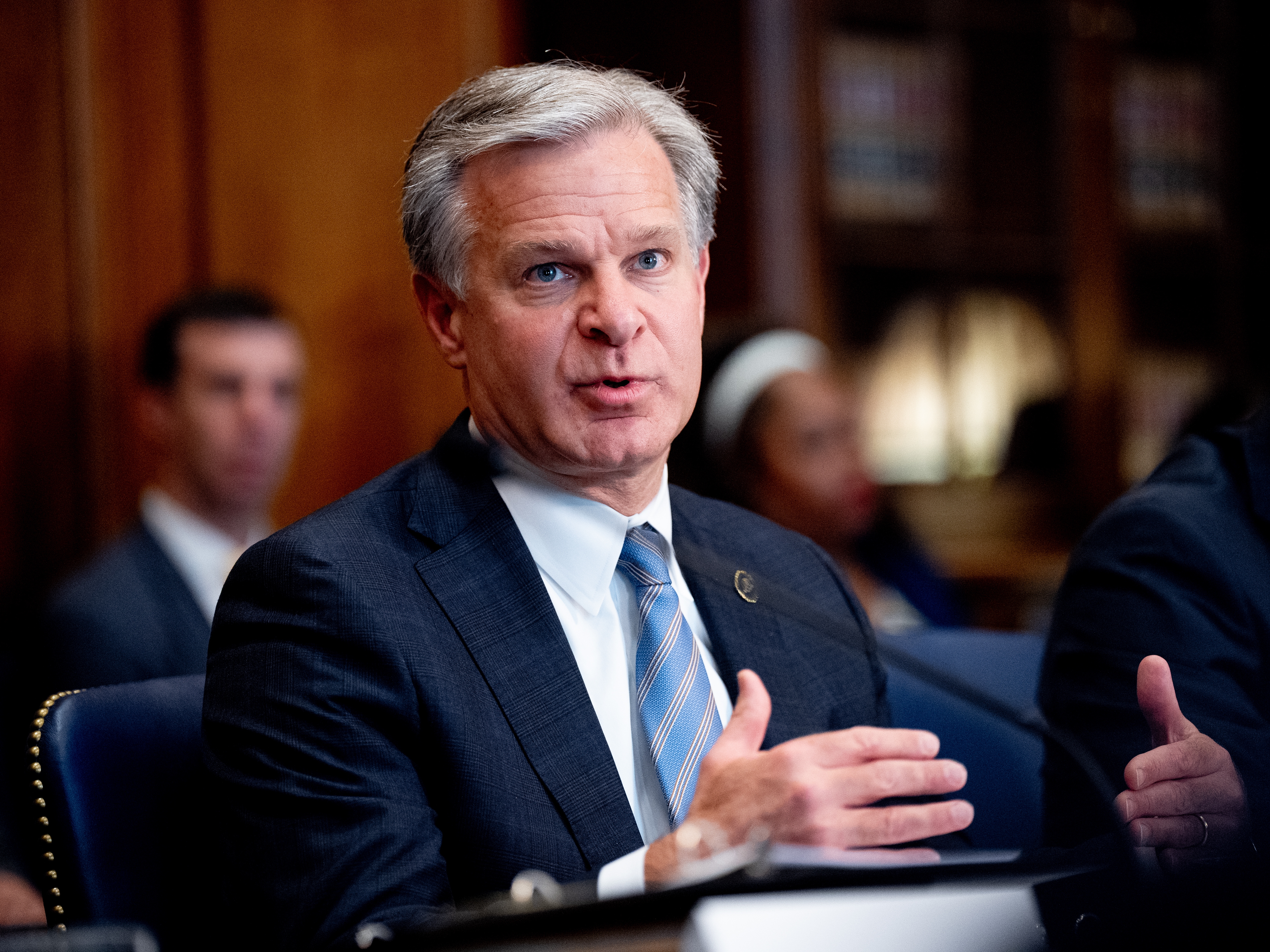 caption: FBI Director Christopher Wray speaks during an Election Threats Task Force meeting at the Justice Department in September 2024.