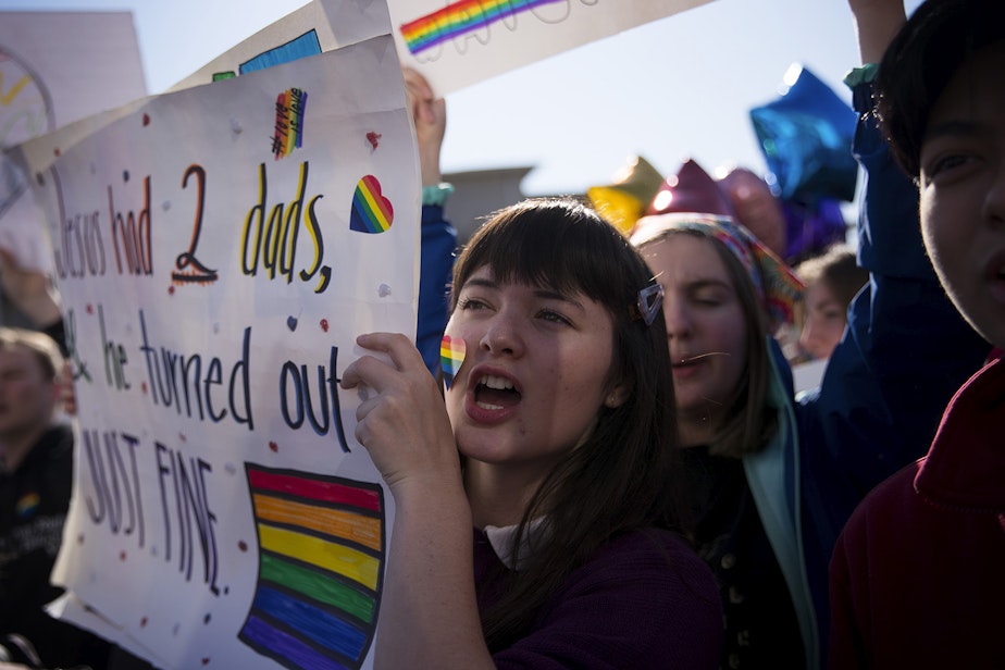 caption: Violet Fitzgerald, a 16-year-old sophomore at Kennedy Catholic High School chants during a student walkout to protest the departure of two LGBT educators on Tuesday, February 18, 2020, in Burien.