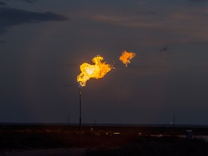 caption: A methane flare seen in Texas. Methane is an incredibly potent greenhouse gas that is currently released in huge quantities by oil and gas operations, landfills and agriculture.