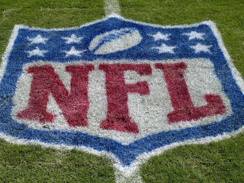 caption: An NFL logo as the Tampa Bay Buccaneers host the Carolina Panthers at Raymond James Stadium on Oct. 12, 2008 in Tampa, Florida. The NFL has suspended all aspects of its COVID-19 protocols, citing recent trends showing that the spread of the coronavirus is declining.