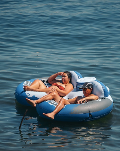 caption: Andrea Portillo, left, and Steven Truong float in Lake Washington at Colman Beach, Monday, June 28. The National Weather Service recorded 108 degrees in SeaTac on Monday, setting an all-time record for the area.