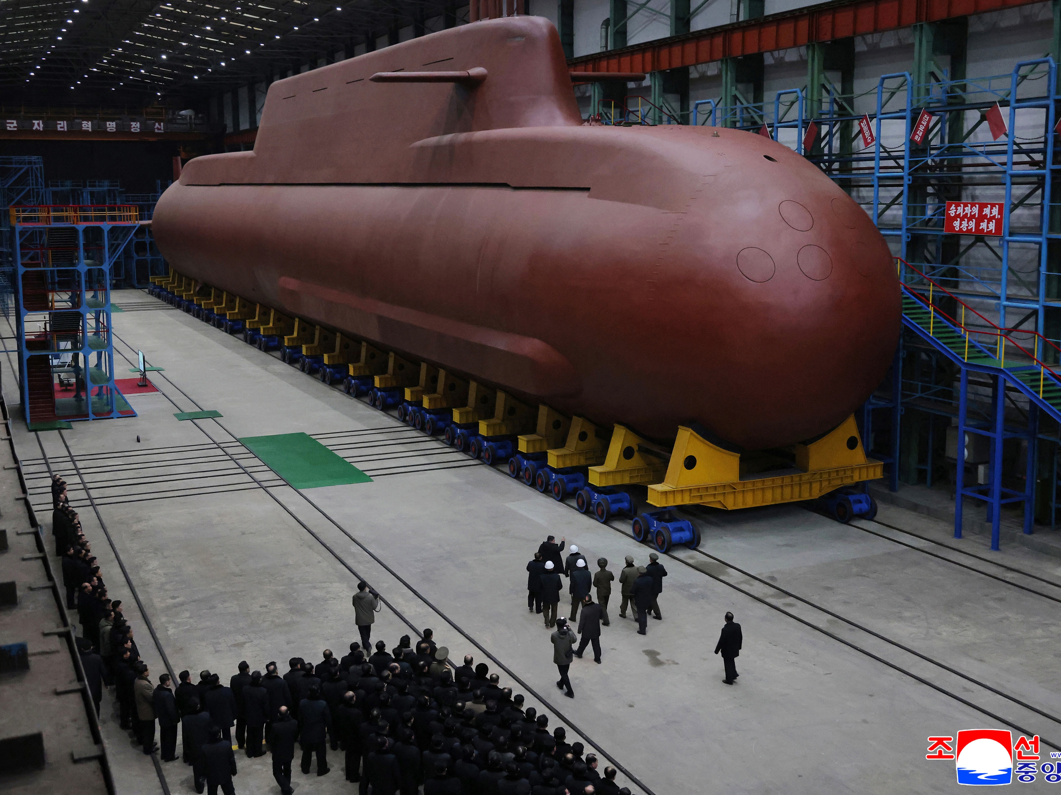 caption: In this undated photo provided Thursday, Dec. 25, 2025, by the North Korean government, its leader Kim Jong Un inspects a nuclear-powered submarine under construction at an undisclosed location in North Korea. Independent journalists were not given access to cover the event depicted in this image distributed by the North Korean government. The content of this image is as provided and cannot be independently verified. Korean language watermark on image as provided by source reads: "KCNA" which is the abbrevi
