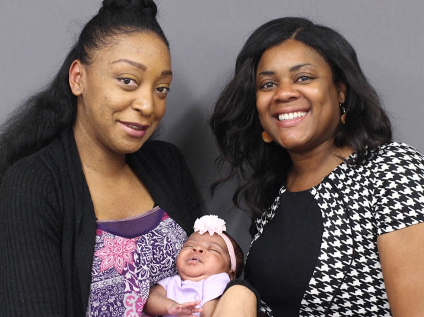 caption: Sabrina Beavers, shown here holding her daughter, Destiny, and her friend, Shantay Davies-Balch, at StoryCorps in 2019.