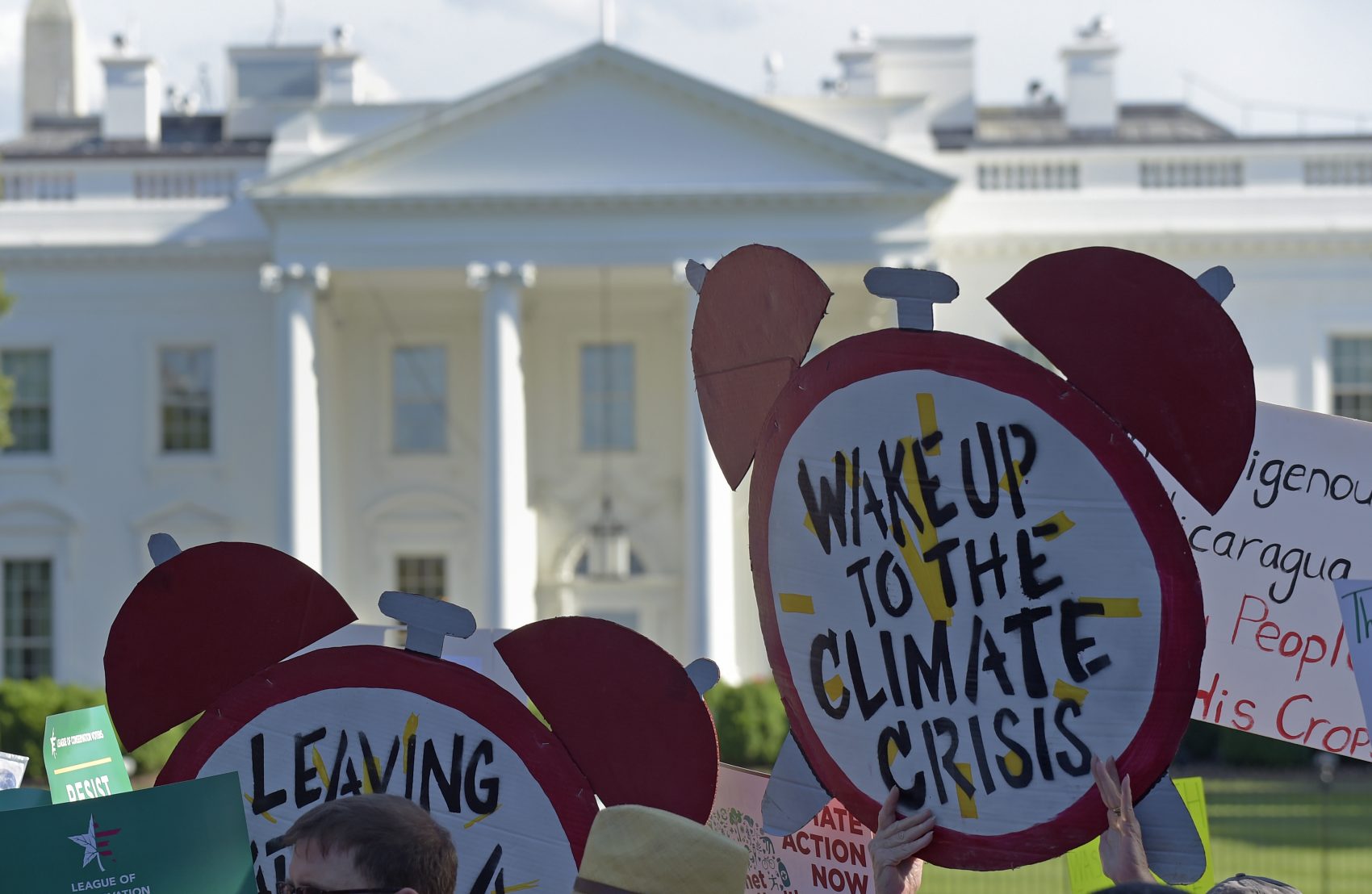 caption: Protesters gather outside the White House in Washington, Thursday, June 1, 2017, to protest President Donald Trump's decision to withdraw the Unites States from the Paris climate change accord. (Susan Walsh/AP)