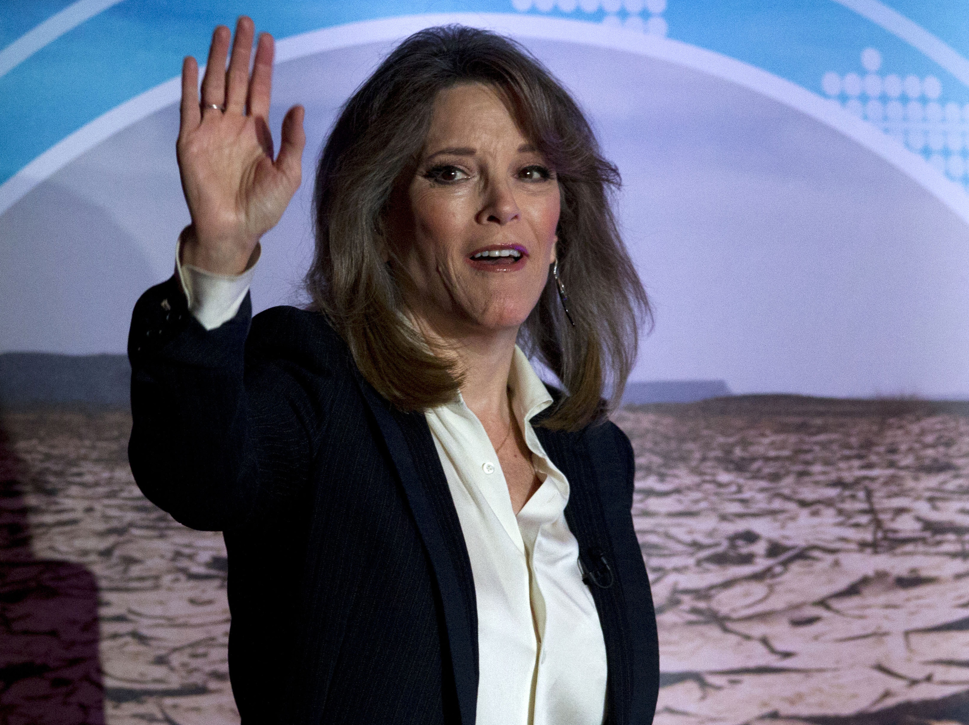 caption: Democratic presidential candidate author Marianne Williamson waves during the Climate Forum at Georgetown University, Thursday, Sept. 19, 2019, in Washington. (AP Photo/Jose Luis Magana)