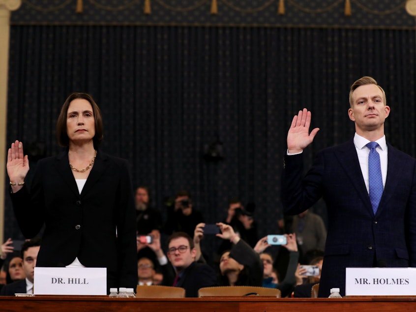 caption: Fiona Hill (left), the National Security Council's former senior director for Europe and Russia, and David Holmes, an official from the American Embassy in Ukraine, are sworn in to testify before the House Intelligence Committee in the Longworth House Office Building on Capitol Hill on Thursday.