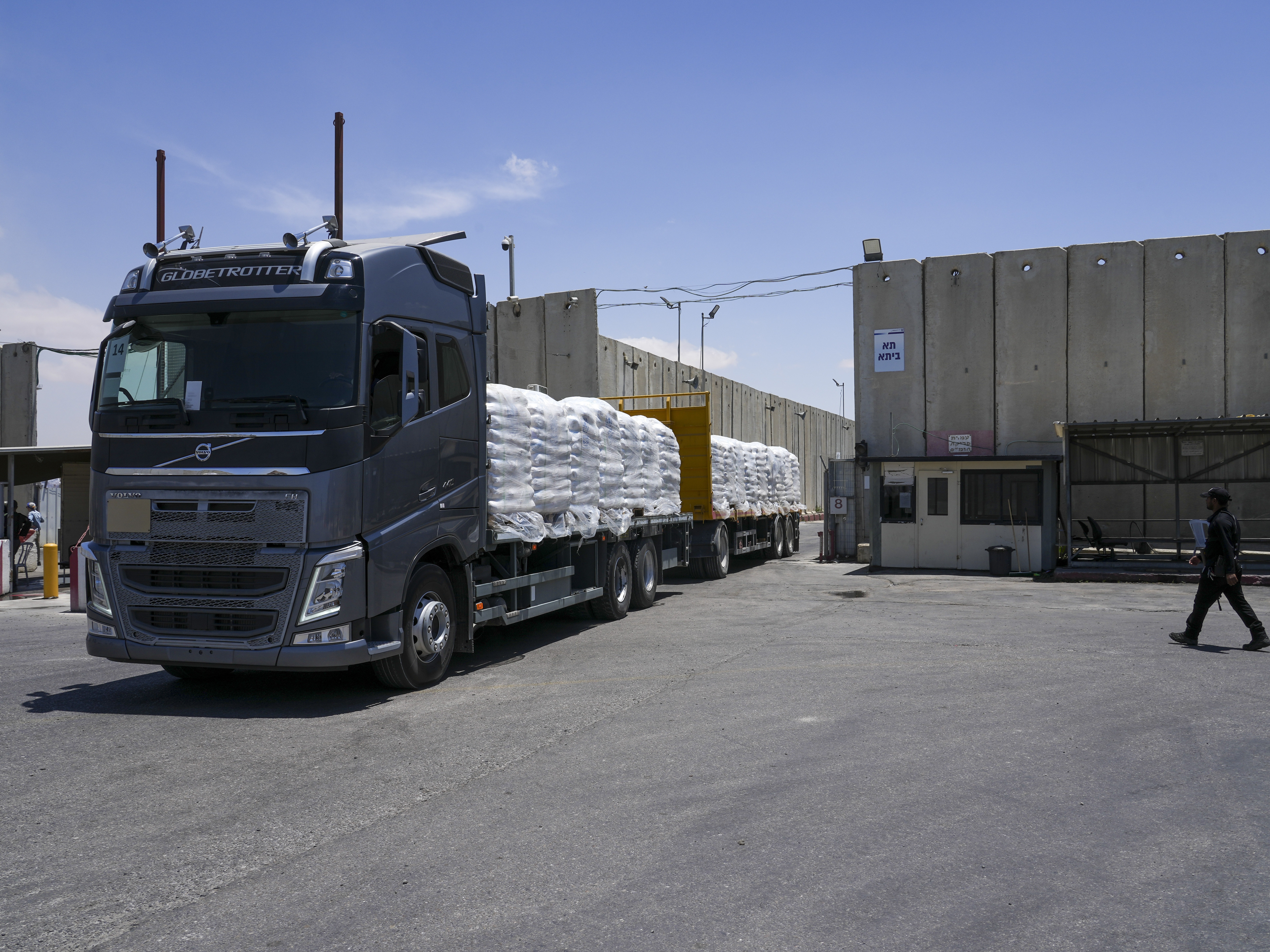 caption: A truck with bundle of humanitarian aid for the Gaza Strip drive at the Kerem Shalom border crossing in southern Israel, Thursday, May 30, 2024.