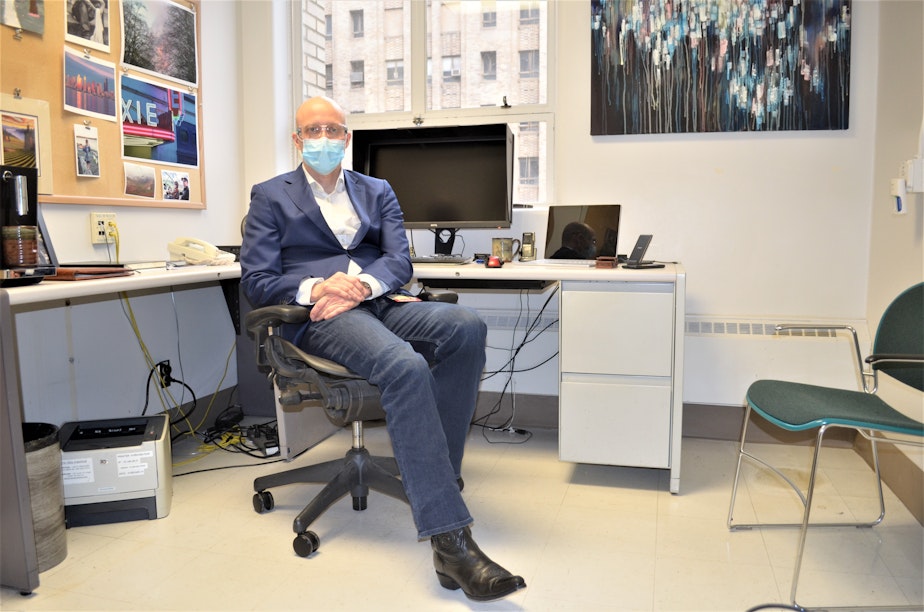 caption: Dr. Aaron Bunnell sits in his office at Harborview's Covid clinic on February 5, 2021.
