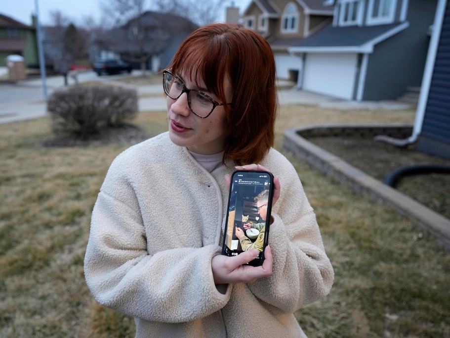 caption: Keira Coady holds a photo of her brother, Sgt. Declan Coady, 20, outside her home Tuesday in West Des Moines, Iowa.