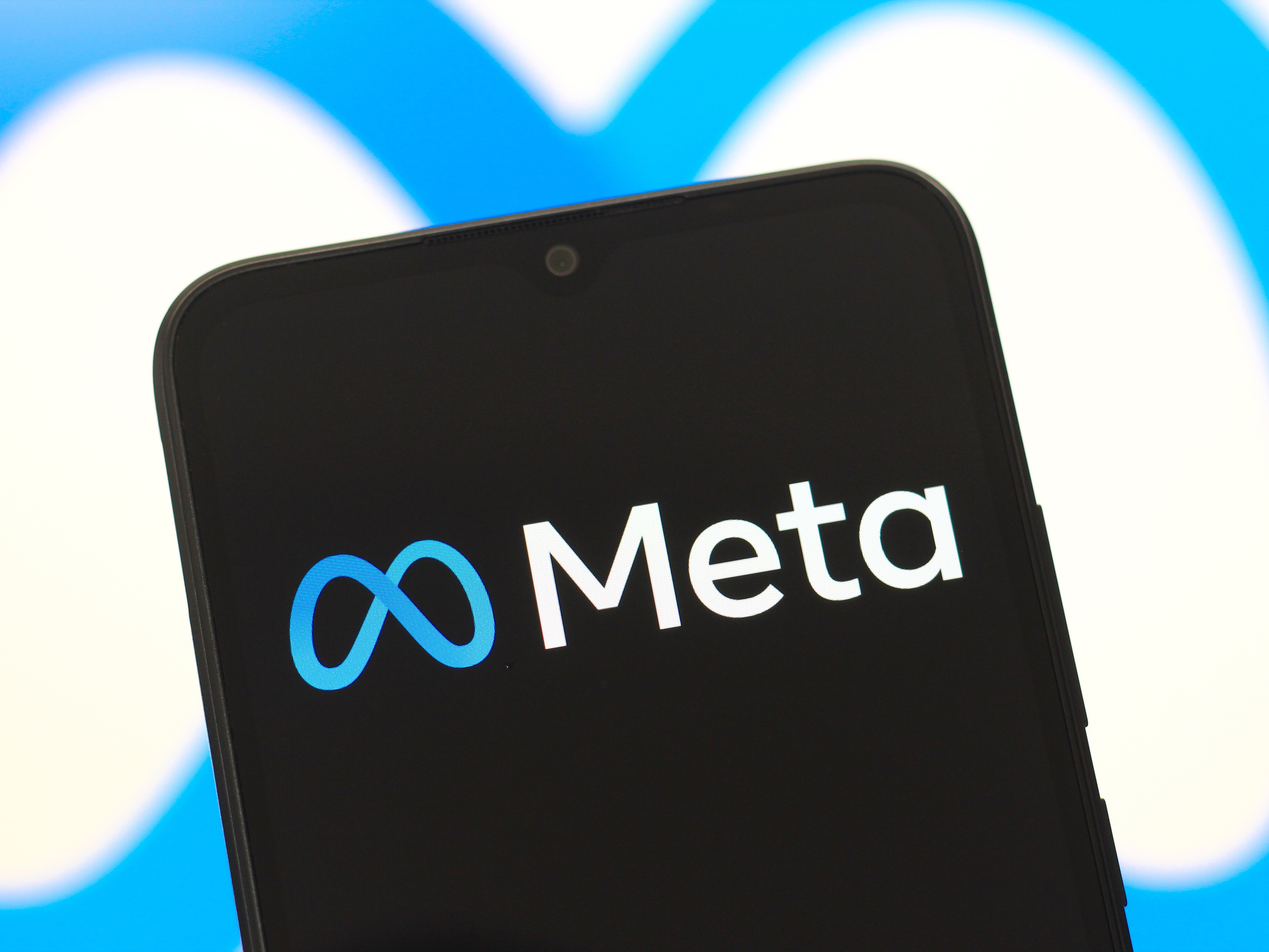 caption: In this photo illustration, the Meta Platforms, Inc. logo is seen displayed on a smartphone screen.