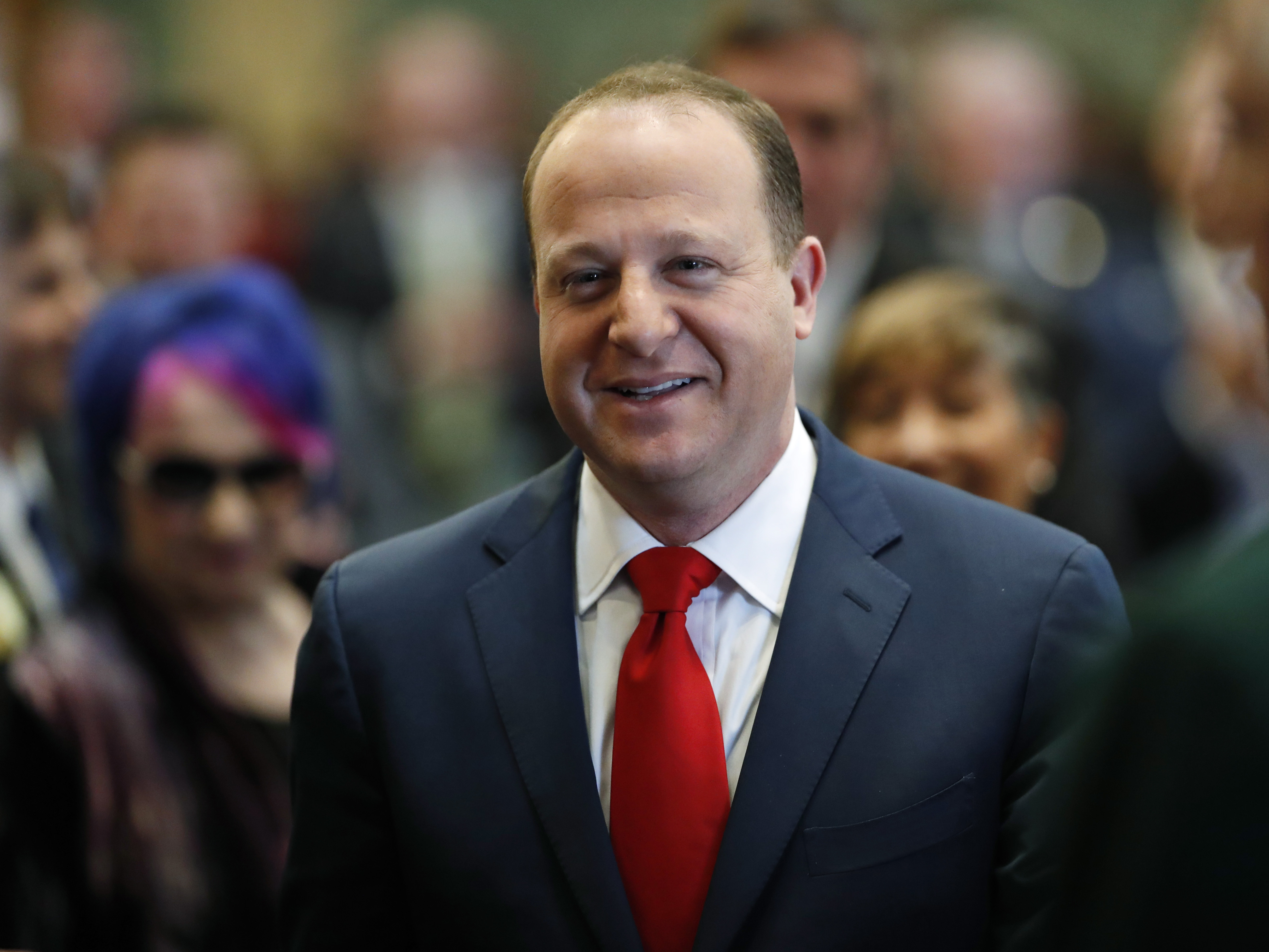 caption: Colorado Gov. Jared Polis, pictured in January, signed a bill into law on Wednesday placing a $100 per month cap on insulin co-payments starting next year.