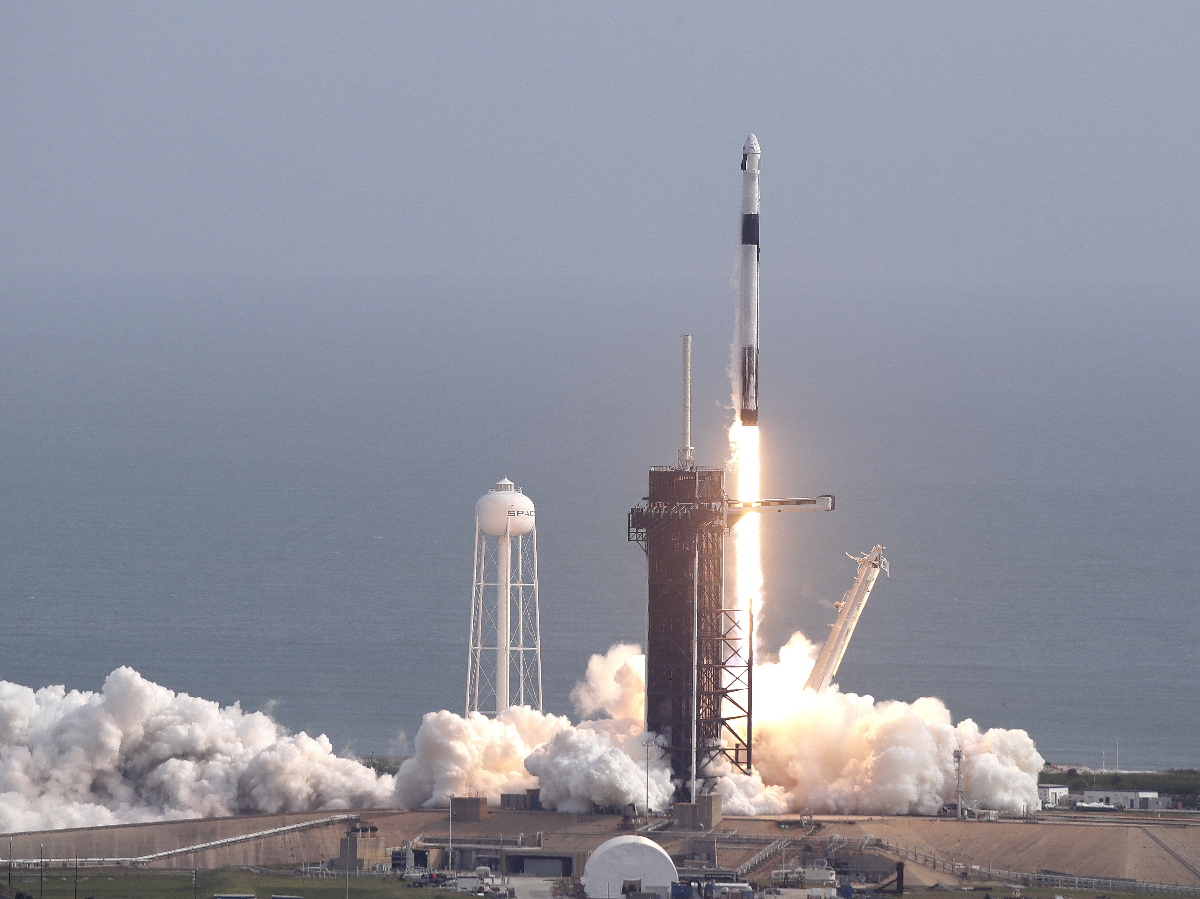 caption: SpaceX successfully tested the emergency escape system of its Crew Dragon capsule on Sunday. The capsule is designed to carry astronauts to the International Space Station for NASA.