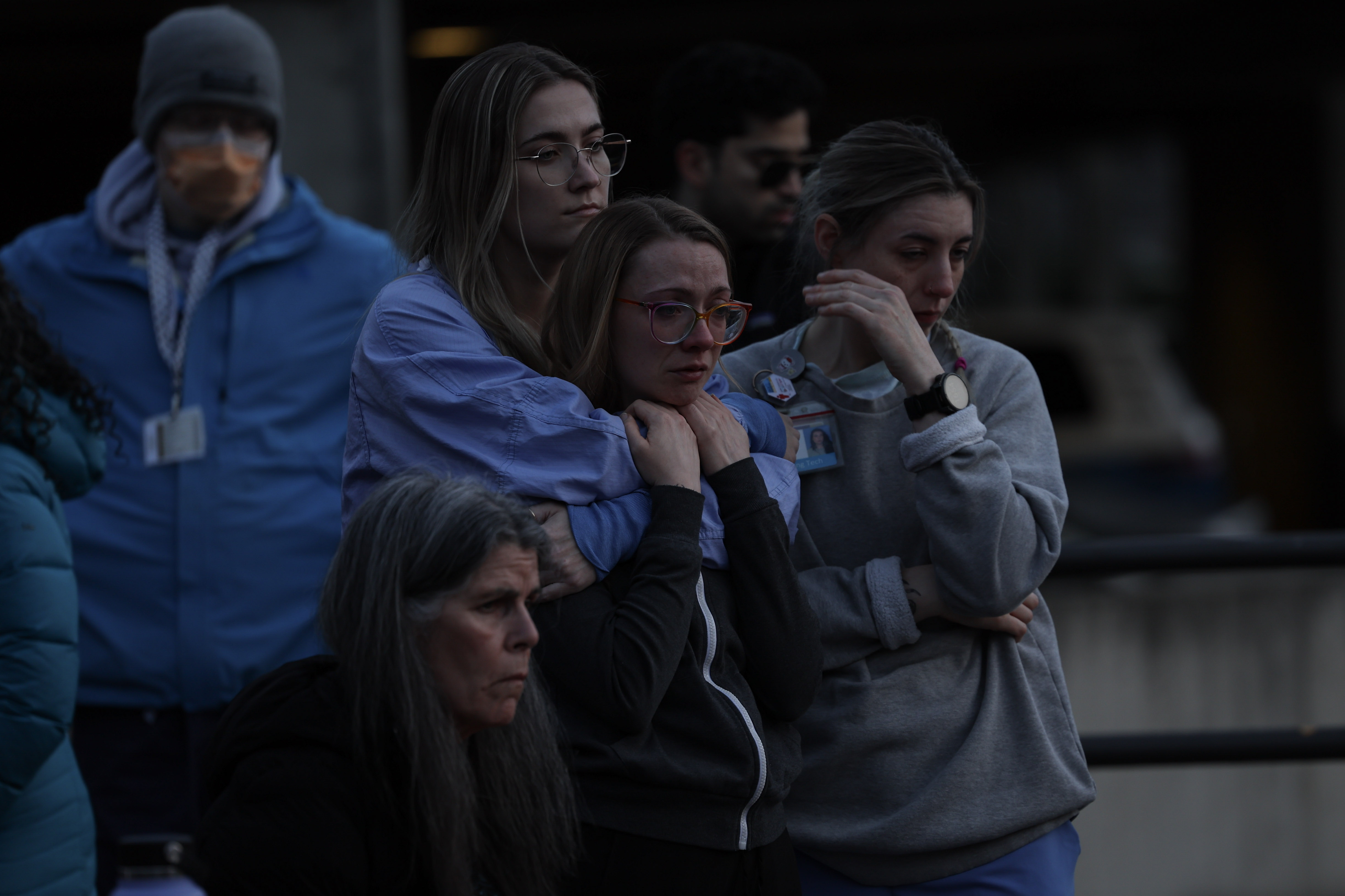 caption: A group of nurses is seing murning the passing of Minessota's nurse Alex Pretti at Harborview Medical Center, Seattle.