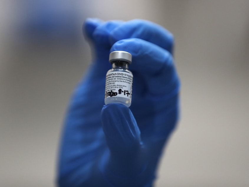 caption: A nurse holds a vial of the COVID-19 vaccine produced by Pfizer and BioNTech, in London earlier this week. Food and Drug Administration officials in the U.S. sought to reassure the public about the vaccine Saturday after authorizing it for emergency use.