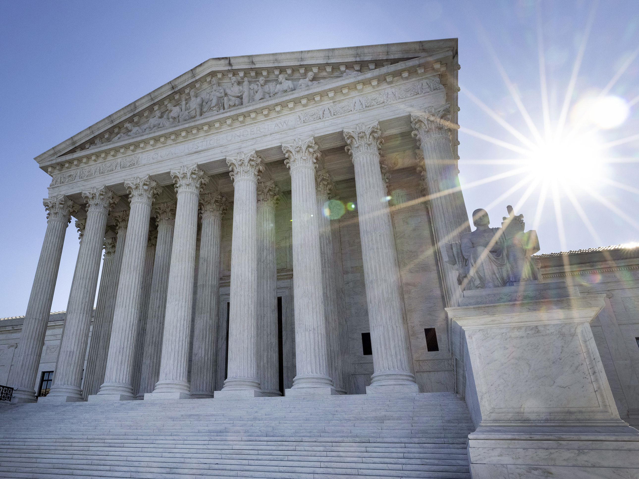 caption: The U.S. Supreme Court will resume in-person oral arguments this fall.