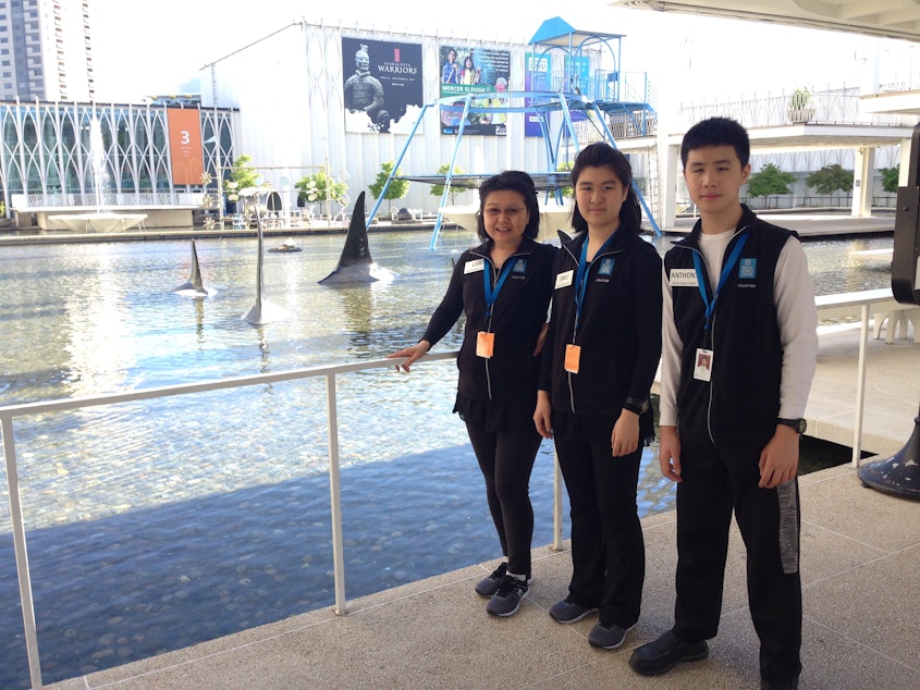 caption: Lisa Chua (left) is a full-time homeschool mom to her two kids Emily and Anthony.
Some high school students in Washington State are required to fulfill a 40-hour community service requirement. Here, Emily and Anthony are seen volunteering for Pacific Science Center’s guest services department. They enjoyed it so much that they ended up contributing over 200 hours each.