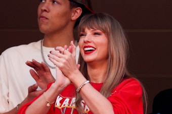 caption: Taylor Swift reacts during a game between the Los Angeles Chargers and Kansas City Chiefs at Arrowhead Stadium in Kansas City, Missouri on October 22, 2023.