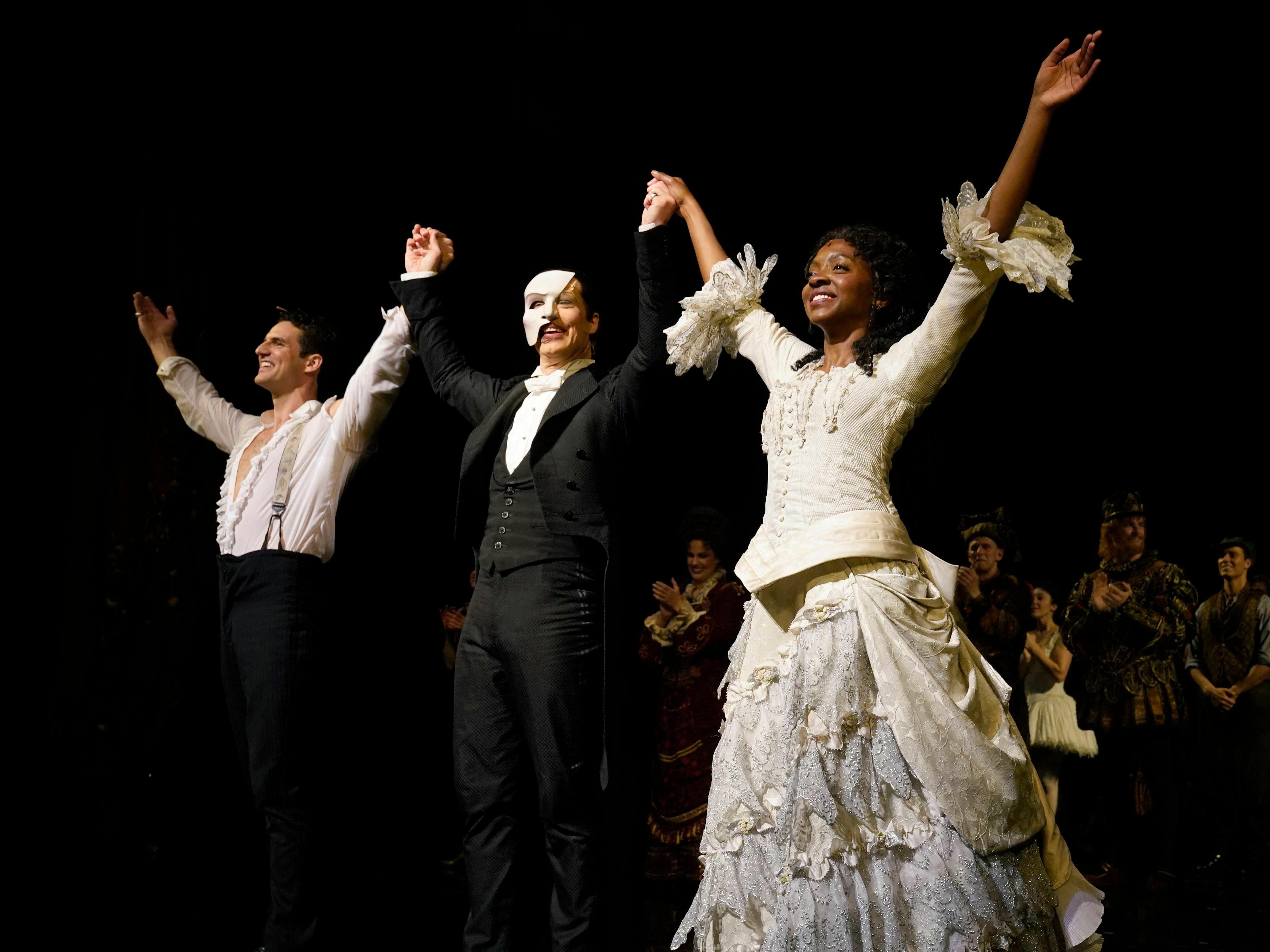 caption: John Riddle as Raoul, Laird Mackintosh as the Phantom and Emilie Kouatchou as Christine, take a bow at the end of the final performance of the <em>Phantom of the Opera</em> at the Majestic Theater in New York City on April 16, 2023.