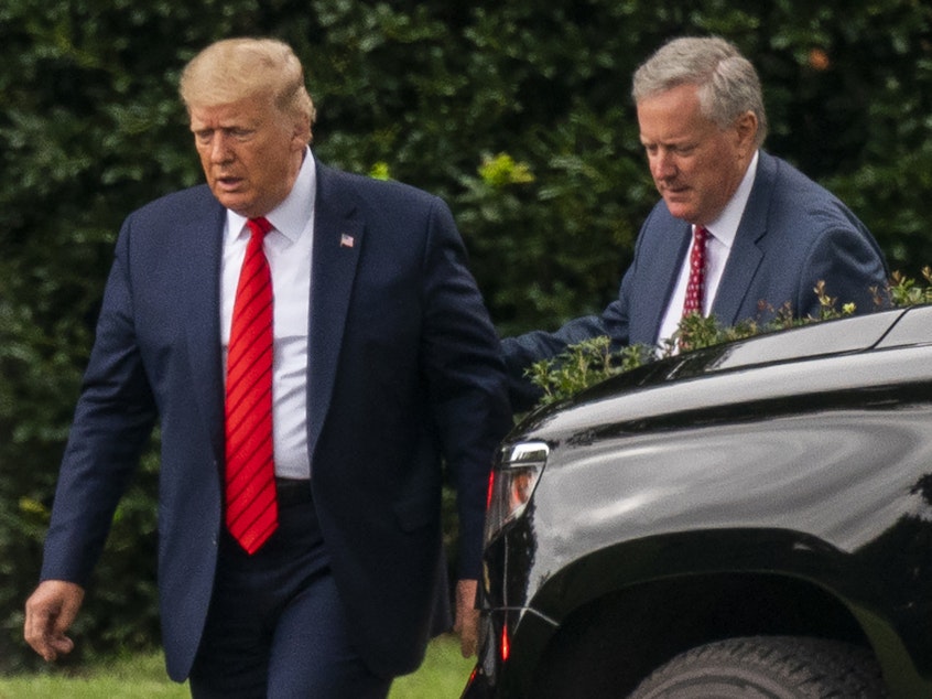 caption: Then-President Donald Trump talks to White House chief of staff Mark Meadows, right, as they walk from the Oval Office at the White House on Sept. 12, 2020.