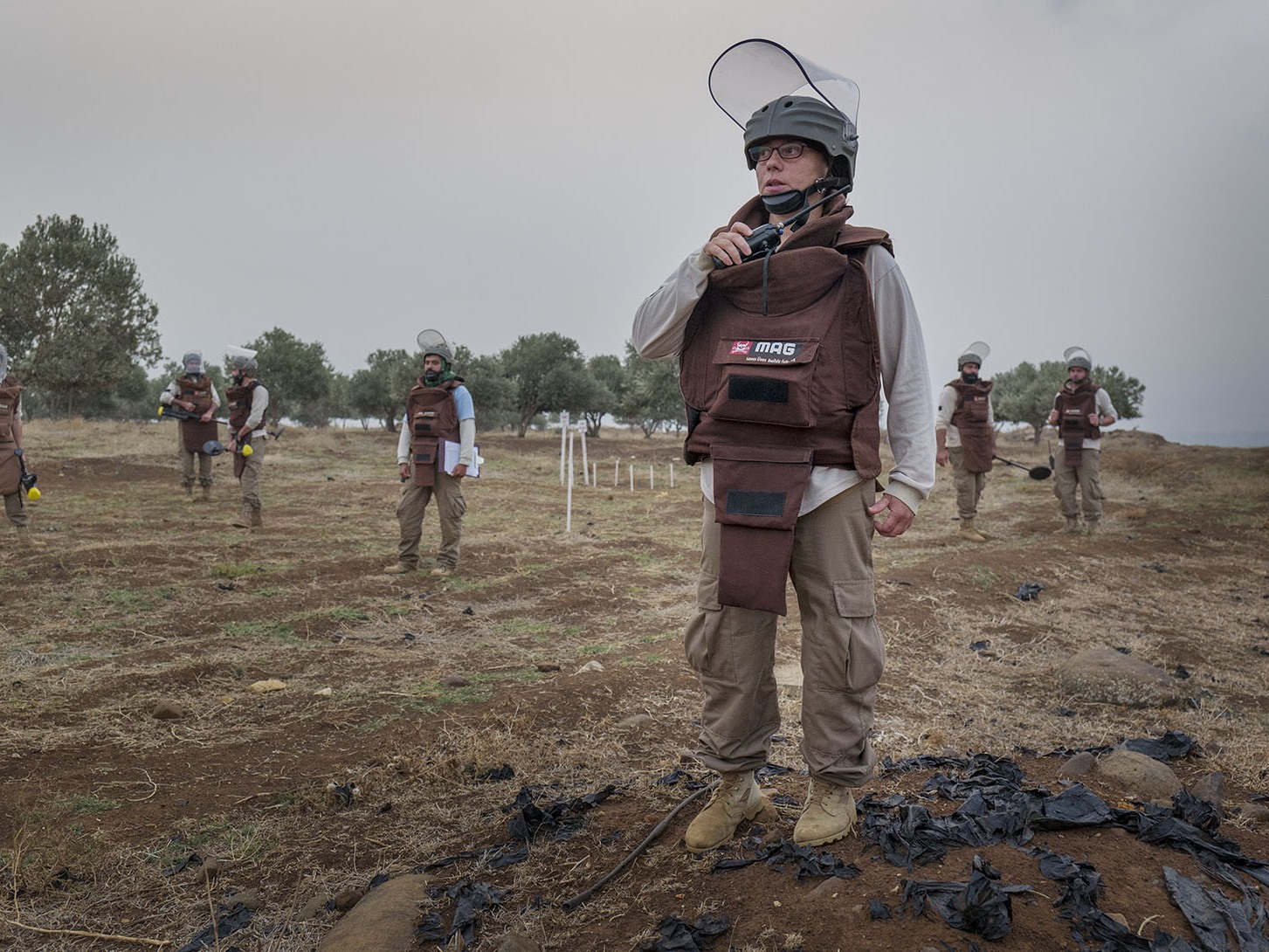 caption: Mofida Majzoub oversees a demining operation in Lebanon. A former wedding photographer, Majzoub switched careers to help people living in areas contaminated with landmines.