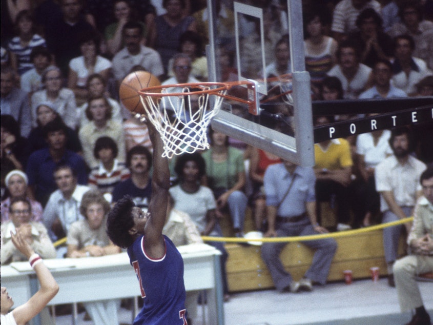 caption: U.S.A. center Lusia Harris finishes a basket in a game against Bulgaria, during the 1976 Summer Olympic Games, in Montreal, on July 20, 1976.
