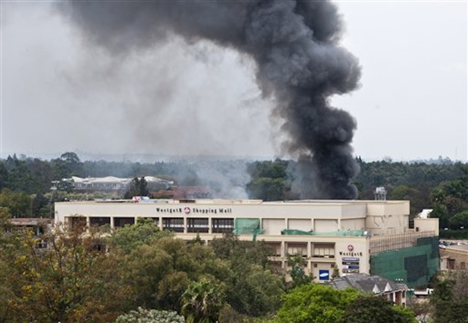 caption: A plume of black smoke billows over the Westgate Mall, in Nairobi, Kenya yesterday.