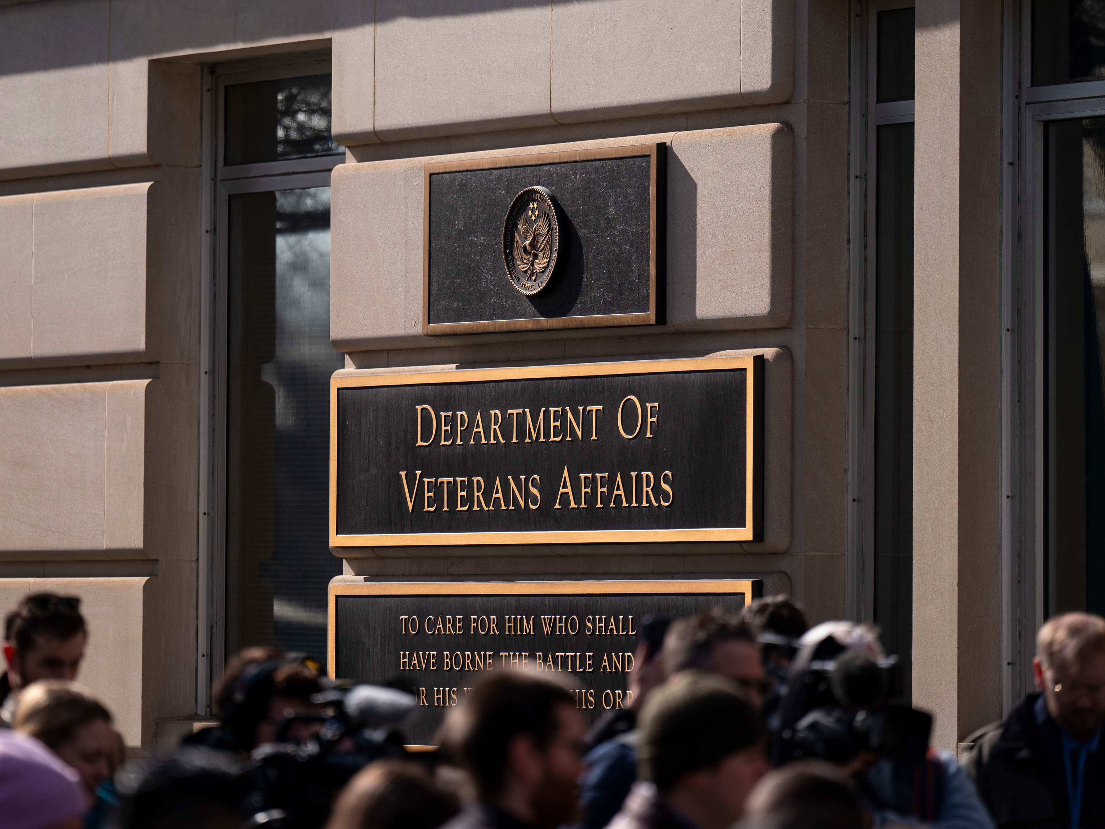caption: Protestors gathered outside the Department of Veterans Affairs headquarters in Washington, DC, US, on Feb. 13, 2025. The agency plans to cut 80,000 jobs.