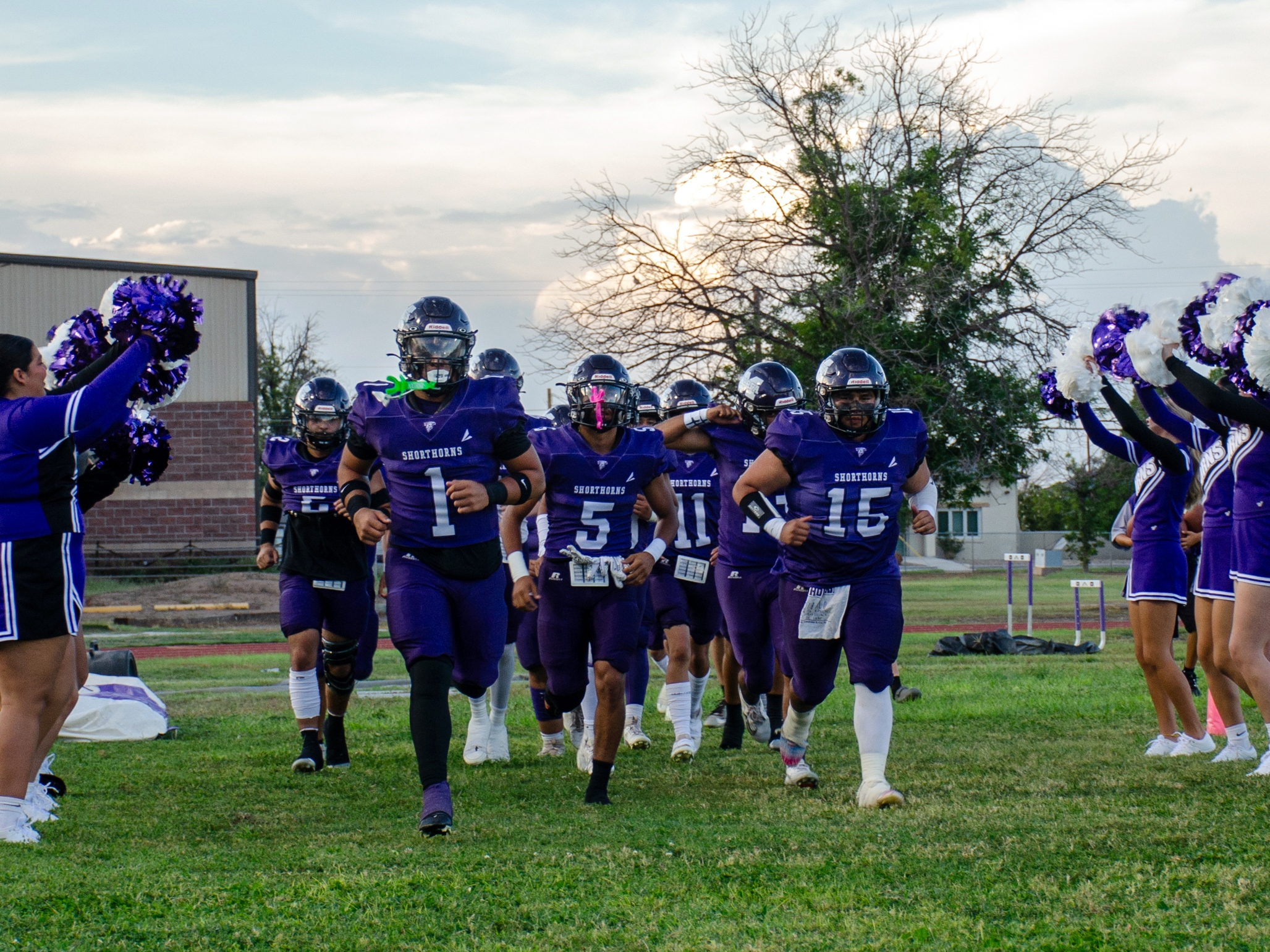 caption: The Marfa Shorthorns take the field with the "shorthorn stampede" before every game during the fall football season.