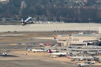 caption: An Alaska Airlines plane takes off from Ronald Reagan National Airport in Arlington, Virginia, on Jan. 18, 2022.