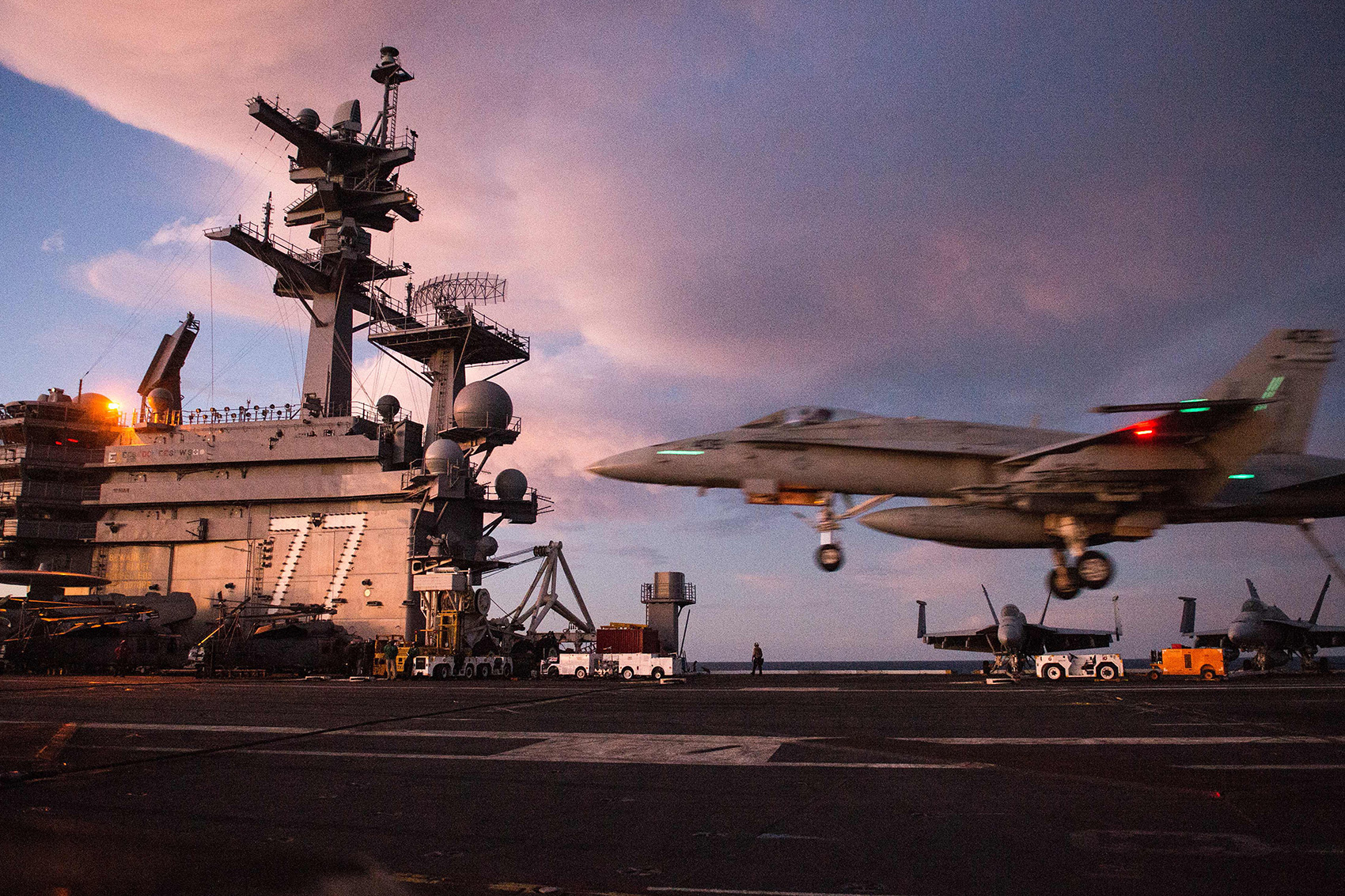 caption: An F/A-18 Hornet lands on the deck of the U.S.S. George H.W. Bush in the Atlantic ocean on Oct. 25, 2017. (Andrew Caballero-Reynolds/AFP/Getty Images)