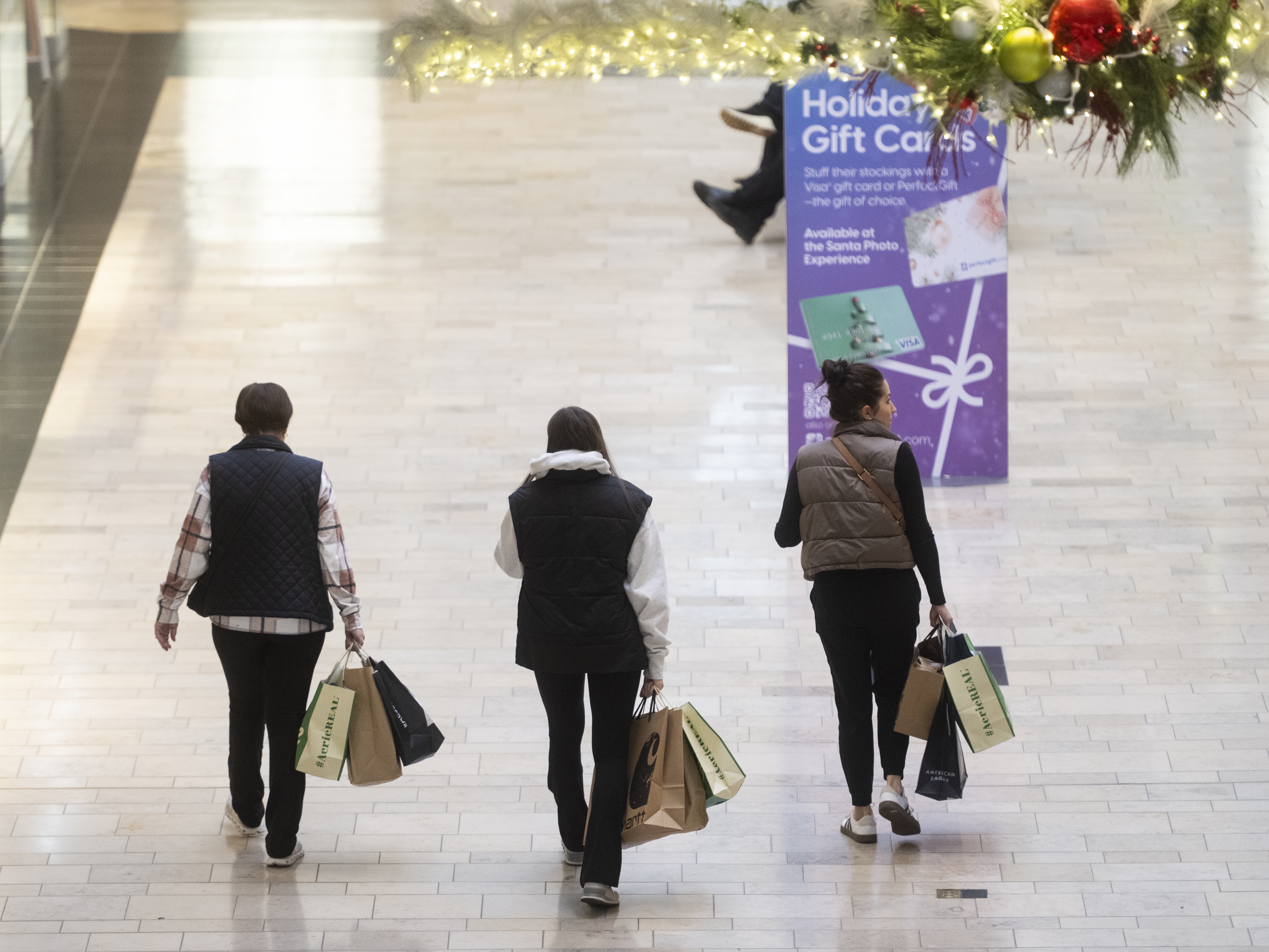 caption: Shoppers walk around Ross Park Mall near Pittsburgh earlier this month. For the first time, the National Retail Federation says, Americans will spend more than $1 trillion on holiday gifts, food and decorations.