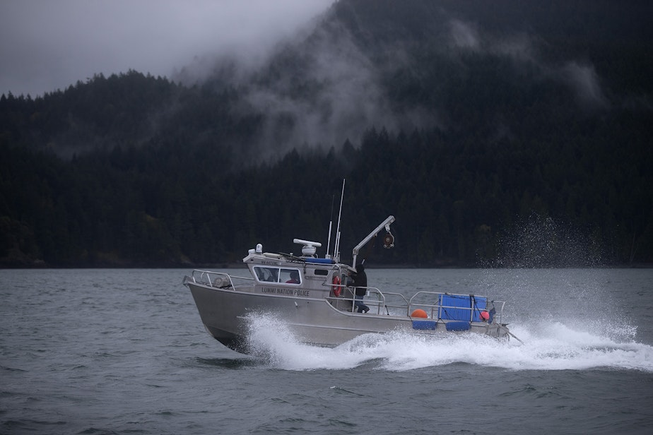 caption: The Lummi Nation police boat returns to Squalicum Harbor after a ceremonial feeding for qwe ‘lhol mechen, meaning the 'relatives that live under the sea', on Wednesday, April 10, 2019, in the waters west of Bellingham.
